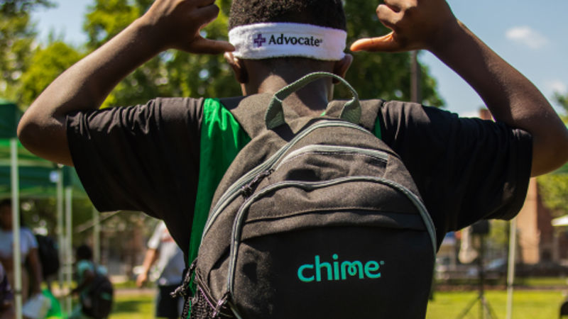 a person with a backpack and a white headband